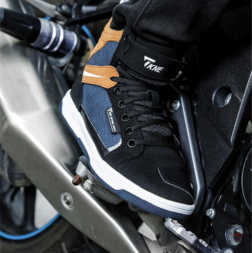 Black and blue sneaker with brown accents on a motorcycle