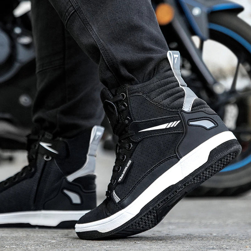 Person wearing black high-top sneakers with white soles on a motorcycle background