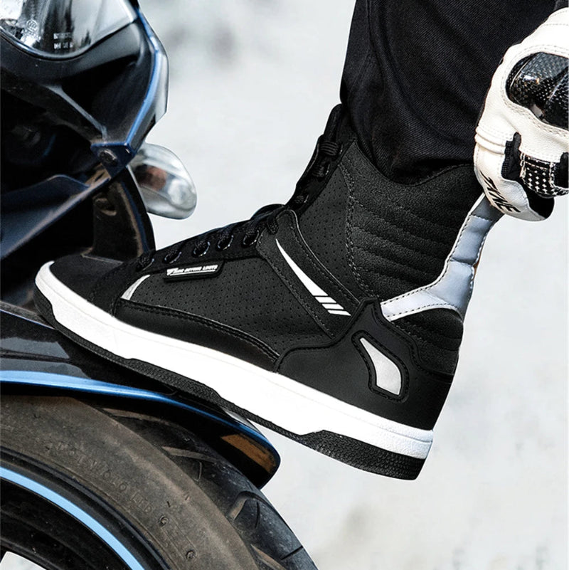 Black motorcycle boot on a motorcycle with a blurred background