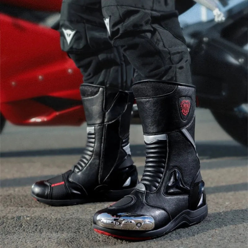 Close-up of black motorcycle boots with a brand logo on a blurred background