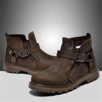Pair of brown leather boots with buckles on a gray background