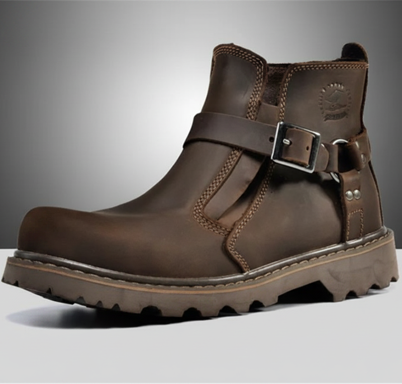 Brown leather boot with a buckle on a gray background