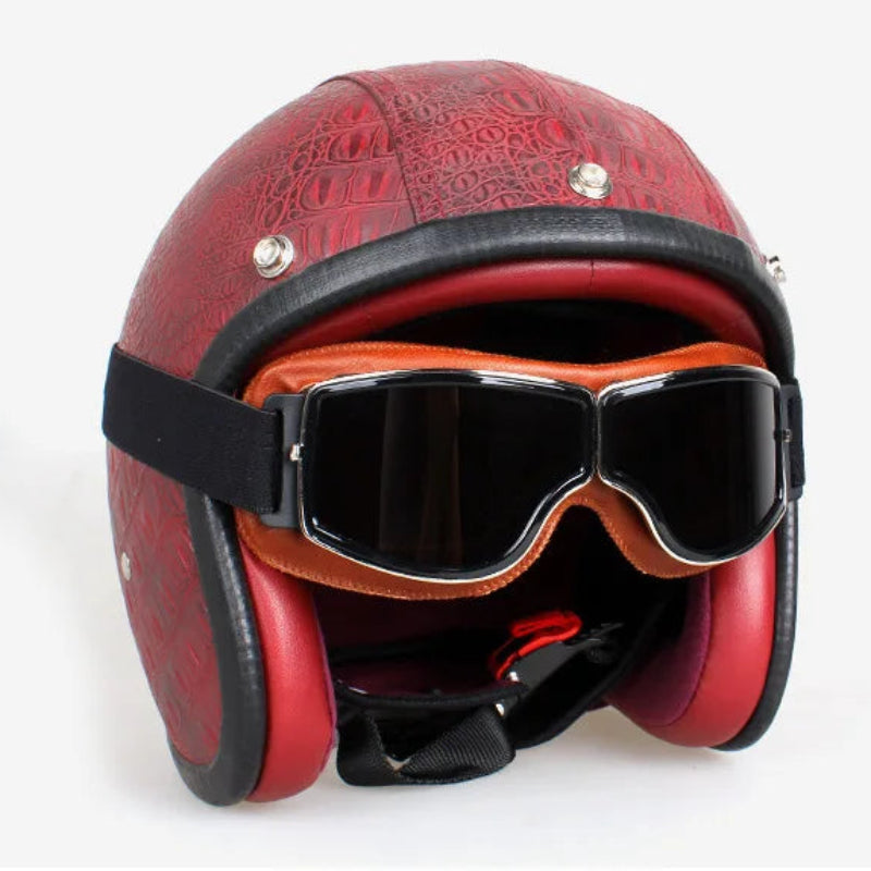 Red leather helmet with goggles on a white background