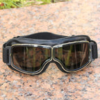 Black goggles with reflective lenses on a textured surface