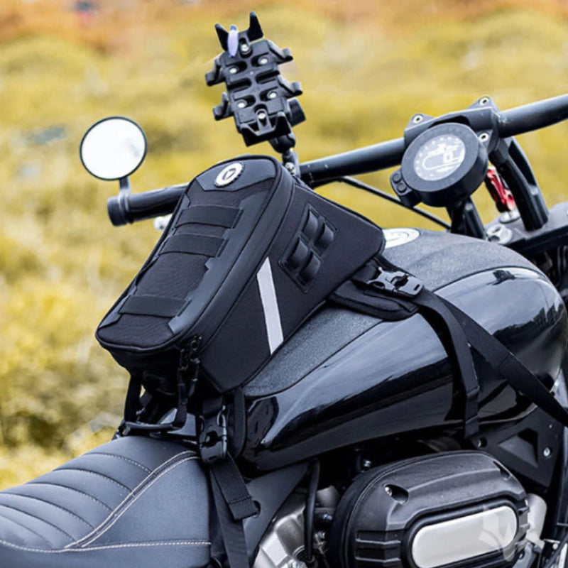 Black motorcycle with a saddlebag and mounted camera on a blurred natural background